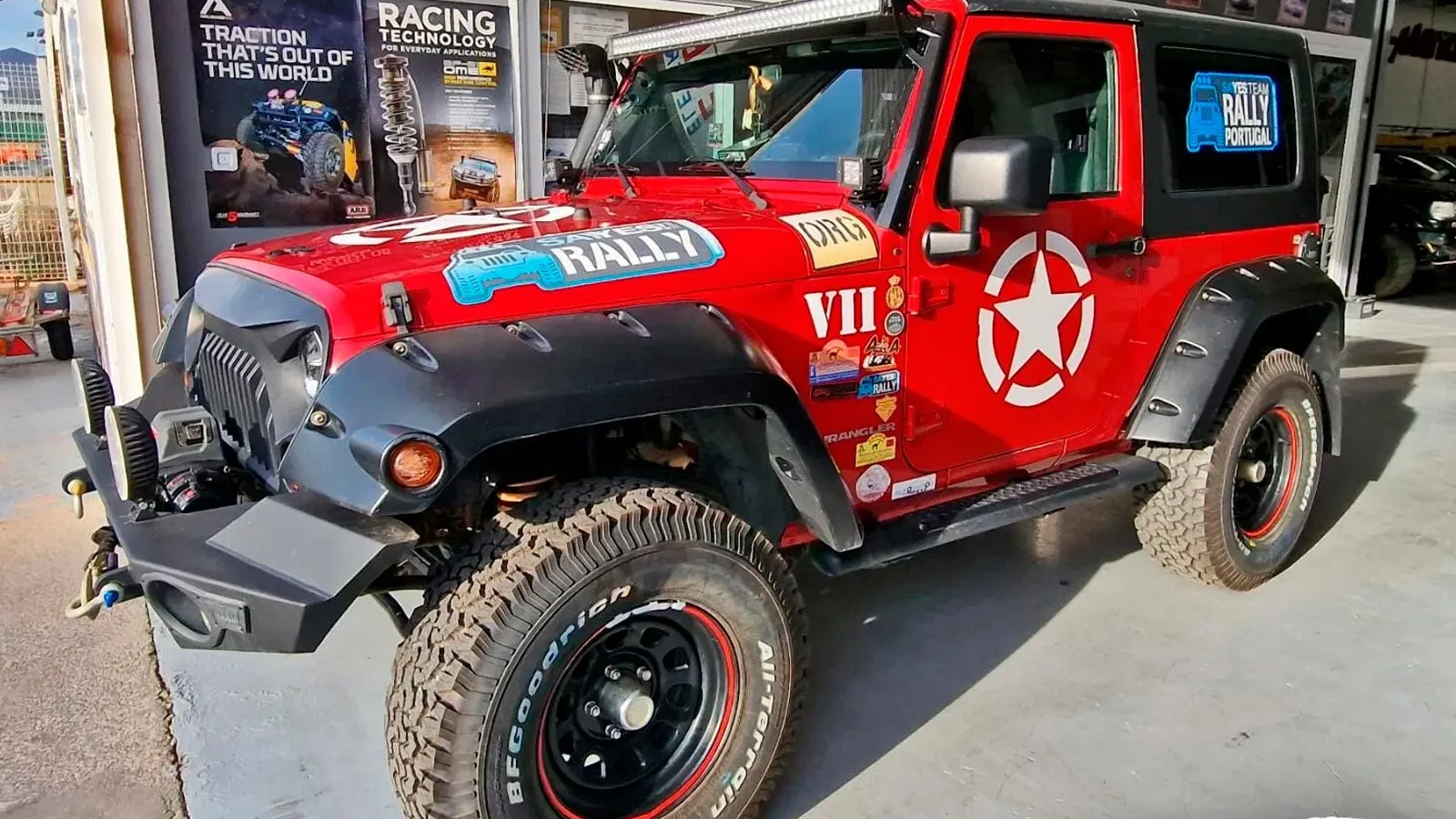 Jeep Wrangler preparado dentro del taller de Automotor 4x4, con el rótulo de mecánica, chapa y pintura al fondo