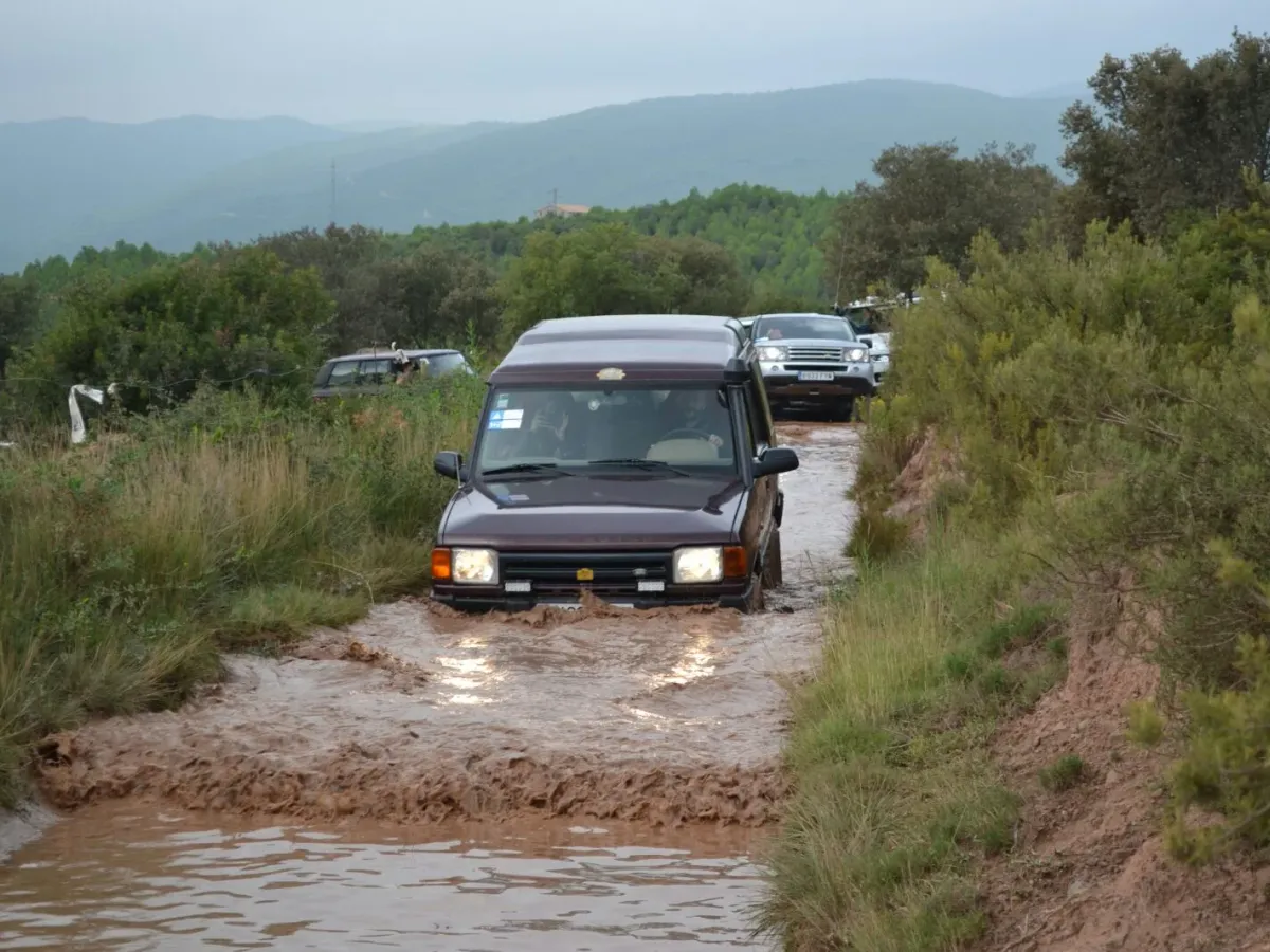 Off-roader crossing a waterlogged, muddy track